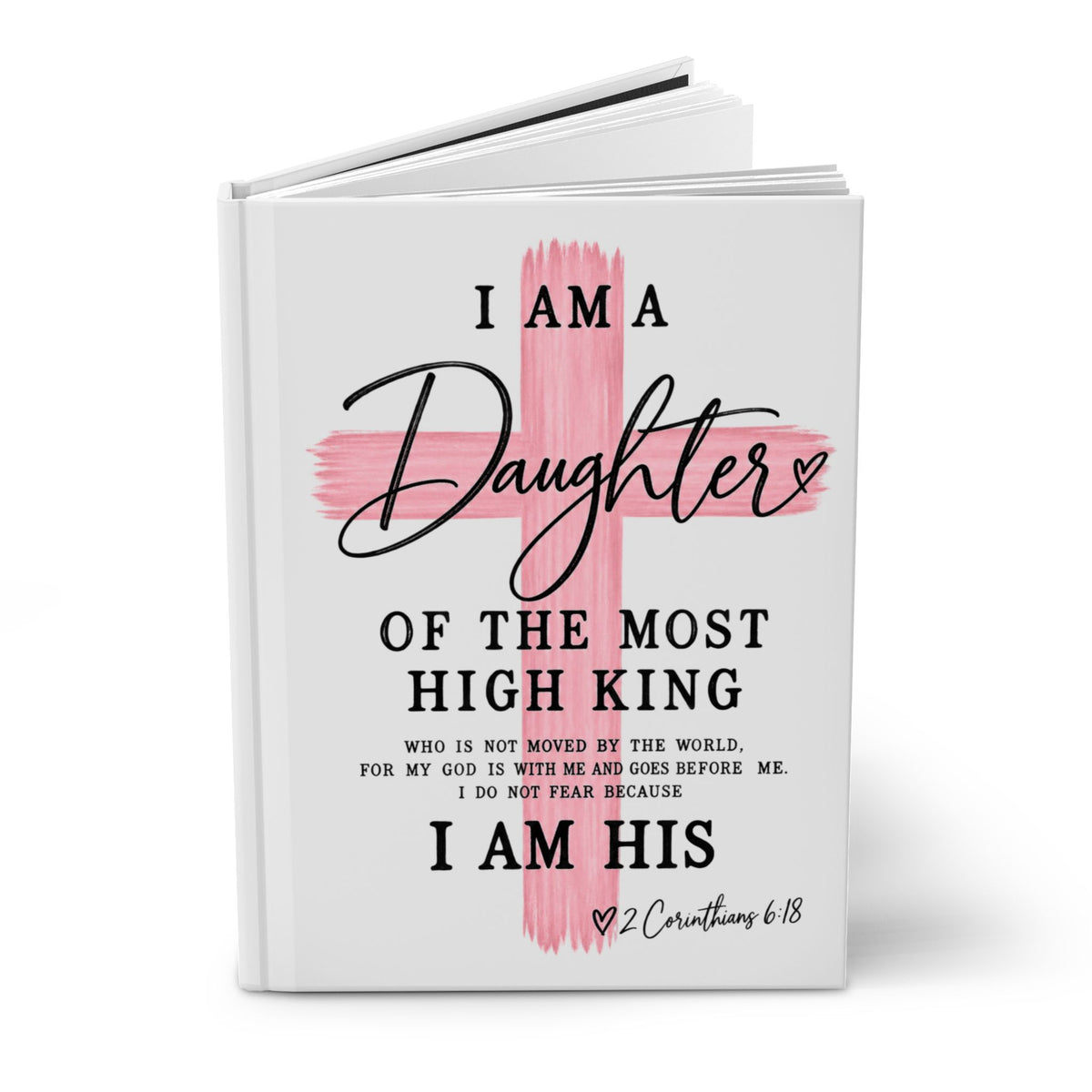 A hardcover book with a white cover featuring a pink painted cross and black text that reads, 'I AM A Daughter OF THE MOST HIGH KING' and 'I AM HIS' with a Bible verse below, shown on a white background.